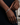 DOLA tennis bracelet featuring original African mask design in 18ct gold, inspired by West African art