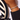 Hand wearing a tennis bracelet with a striped white and black plate on a table, featuring 'Oriki Line' branding.